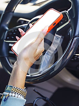 Young female driver using touch screen smartphone and gps navigation in a car. mock-up