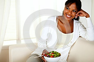 Young female eating healthy salad lunch