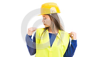 Young female engineer adjusting her vest