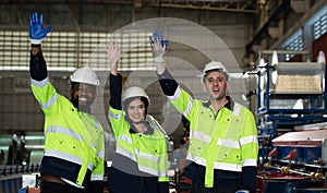 Young female engineer learning to run machinery at a factory with veteran engineers