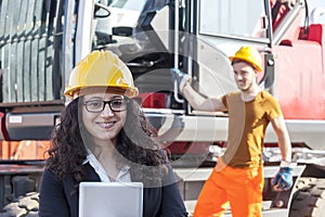 Young female engineer posing in junkyard