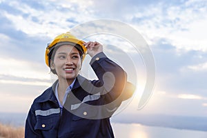 Young female engineer smiling and holding harthat looking to the future