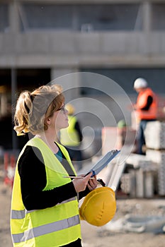 Young female engineer at work on construction site