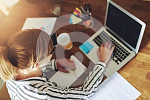 Young female entrepreneur working in a home office photo
