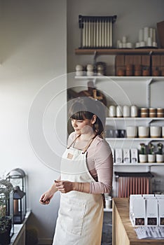 Young female florist busy working in her flower shop