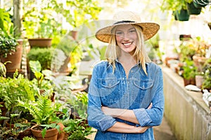 Young female gardener at greenhouse