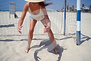 Young female goalkeeper catching a ball
