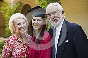 Young Female Graduate With Grandparents