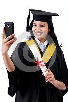 Young female graduated student taking selfie