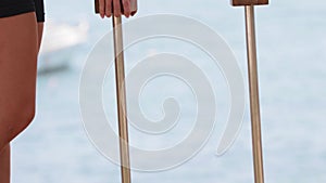 A young female gymnast uses high bars on the beach for her training