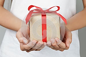 Young female hands holding gift