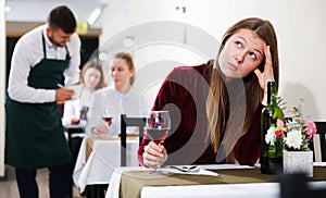 Young female is having dinner alone in the restaurante