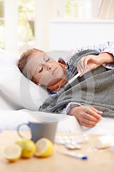 Young female having flu laying in bed