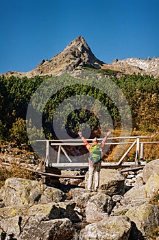 Young female hiker celebrating success enjoying nature in Slovak