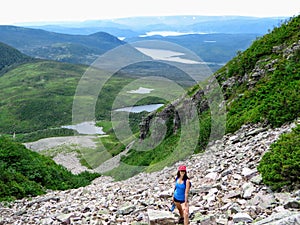 A young female hiker climbing near the summit of Gros Morne Mountain, in Gros Morne National Park, Newfoundland and Labrador