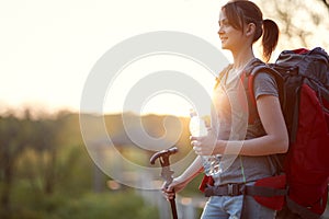 Young female hiker enjoying at dawn  in nature. healthy living, positive, nature concept