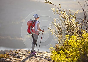 Young female hiker standing on cliff