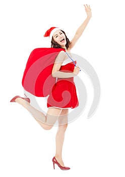 Young female holding a gift bag with Christmas suit running and