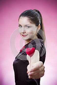 Young female holding a heart