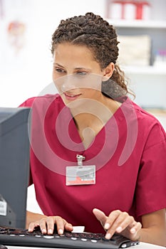 Young female hospital doctor at desk