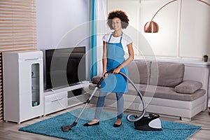 Janitor Cleaning Carpet With Vacuum Cleaner photo