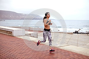 Young female jogger on the esplanade