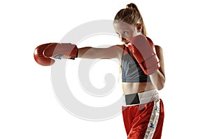 Young female kickboxing fighter training isolated on white background