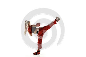 Young female kickboxing fighter training isolated on white background