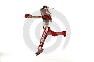 Young female kickboxing fighter training isolated on white background