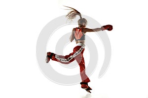Young female kickboxing fighter training isolated on white background