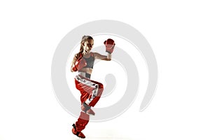 Young female kickboxing fighter training isolated on white background