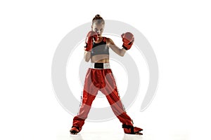 Young female kickboxing fighter training isolated on white background