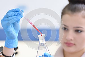 Young female Laboratory scientist working at lab with test tubes and microscope, test or research in clinical laboratory.Science,