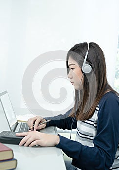 Young female long hair sitting in living room and learning online