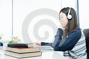 Young female long hair sitting in living room and learning online