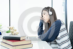 Young female long hair sitting in living room and learning online