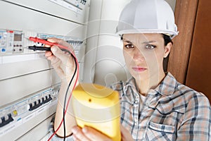 young female maintenance engineer testing voltage