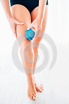 Young female making massage using a silicone cup for vacuum Cupping anti-cellulite Massage Therapy on her thigh zone skin