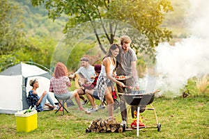 Young female and male couple baking barbecue