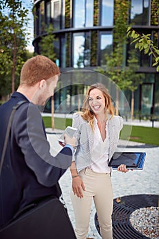 Young female and male coworkers flirting