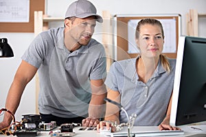 young female and male workers in factory