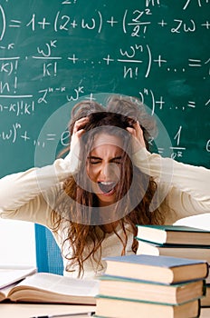 The young female math teacher in front of chalkboard