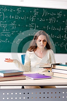 The young female math teacher in front of chalkboard