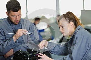 young female mechanic practicing to repair