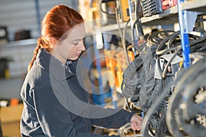 Young female mechanic working at garage