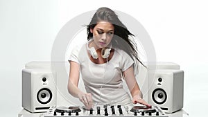 Young Female Mixing Music Using DJ Mixer