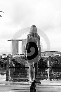 Young female model is posing in front of legendary Marina Bay Sands in Singapore.