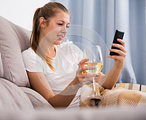 Young female with modern mobile and wine