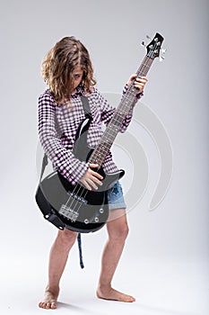 Young female musician playing an electric guitar