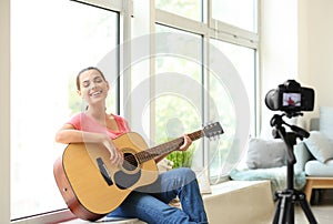 Young female musician recording video at home